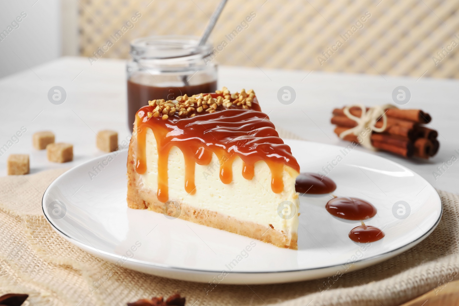 Photo of Tasty cheesecake with caramel and nuts served on table