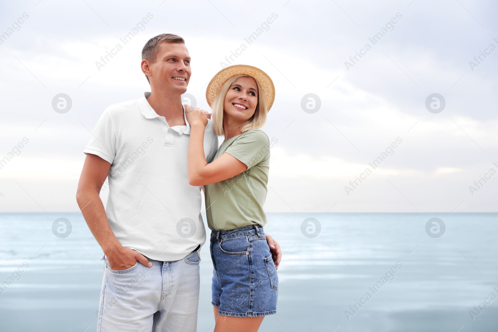 Photo of Happy couple near sea on sunny summer day