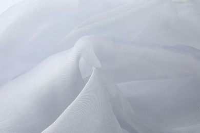 Photo of Texture of white tulle fabric as background, closeup