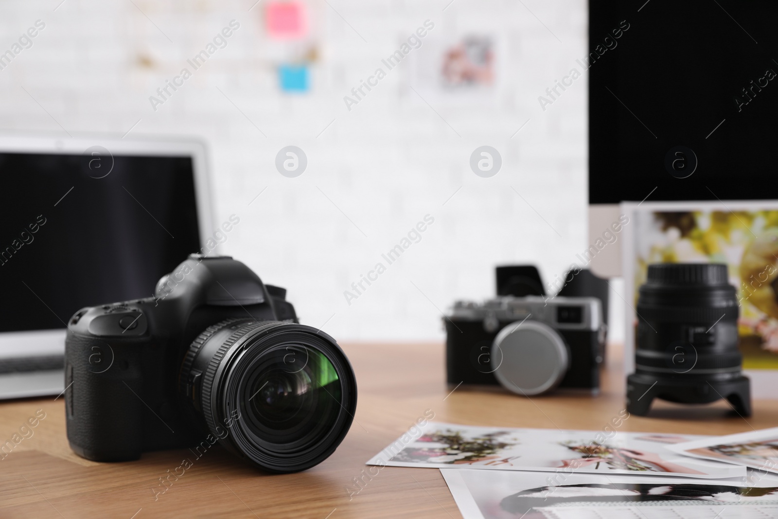 Photo of Photographer's workplace with professional camera in office