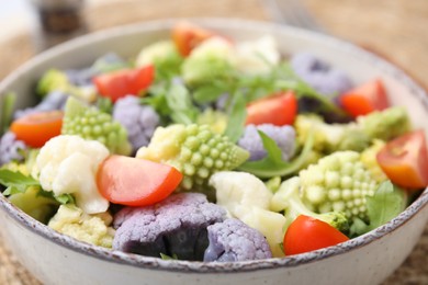 Delicious salad with cauliflower and tomato, closeup