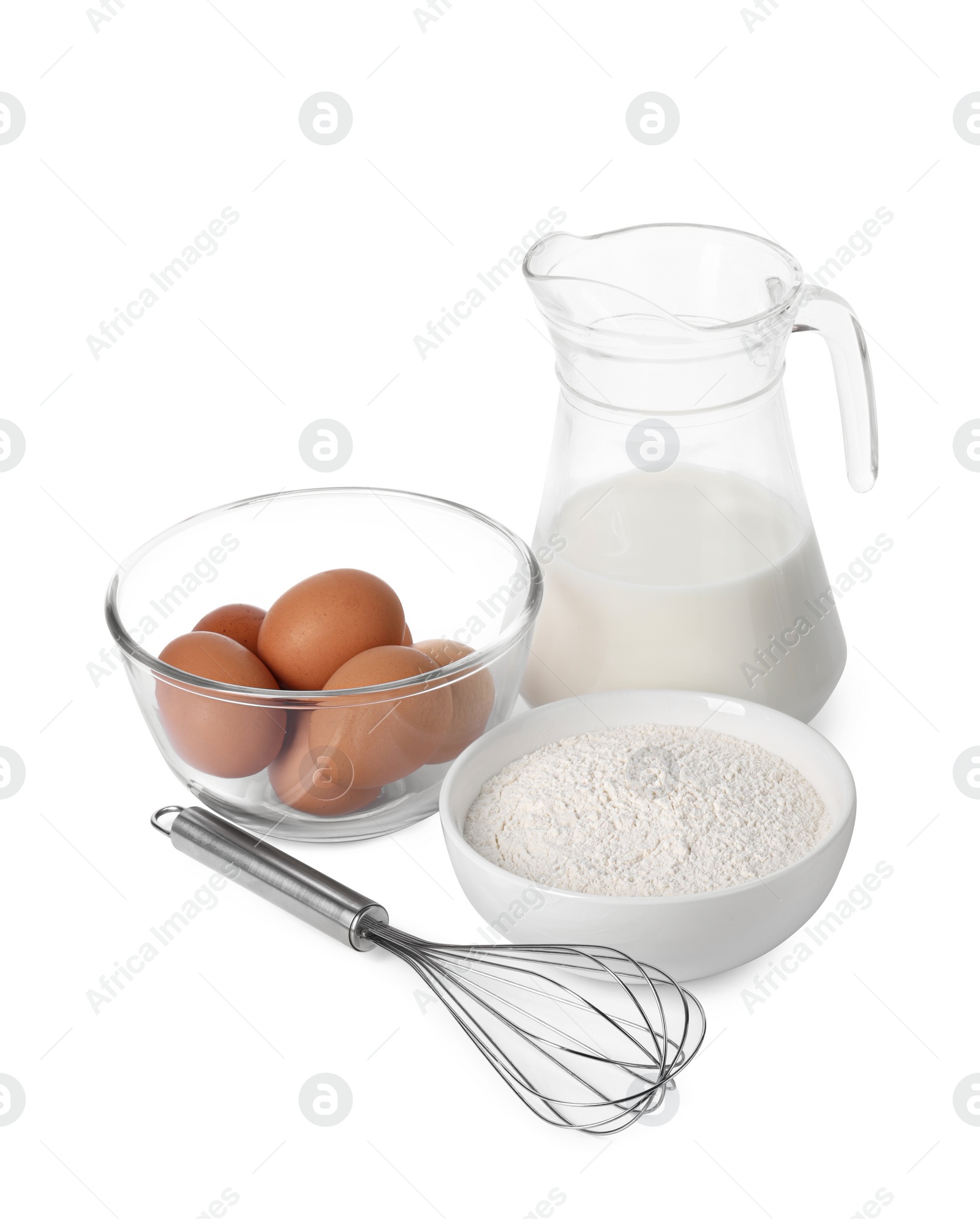 Photo of Metal whisk, raw eggs, flour and jug of milk isolated on white