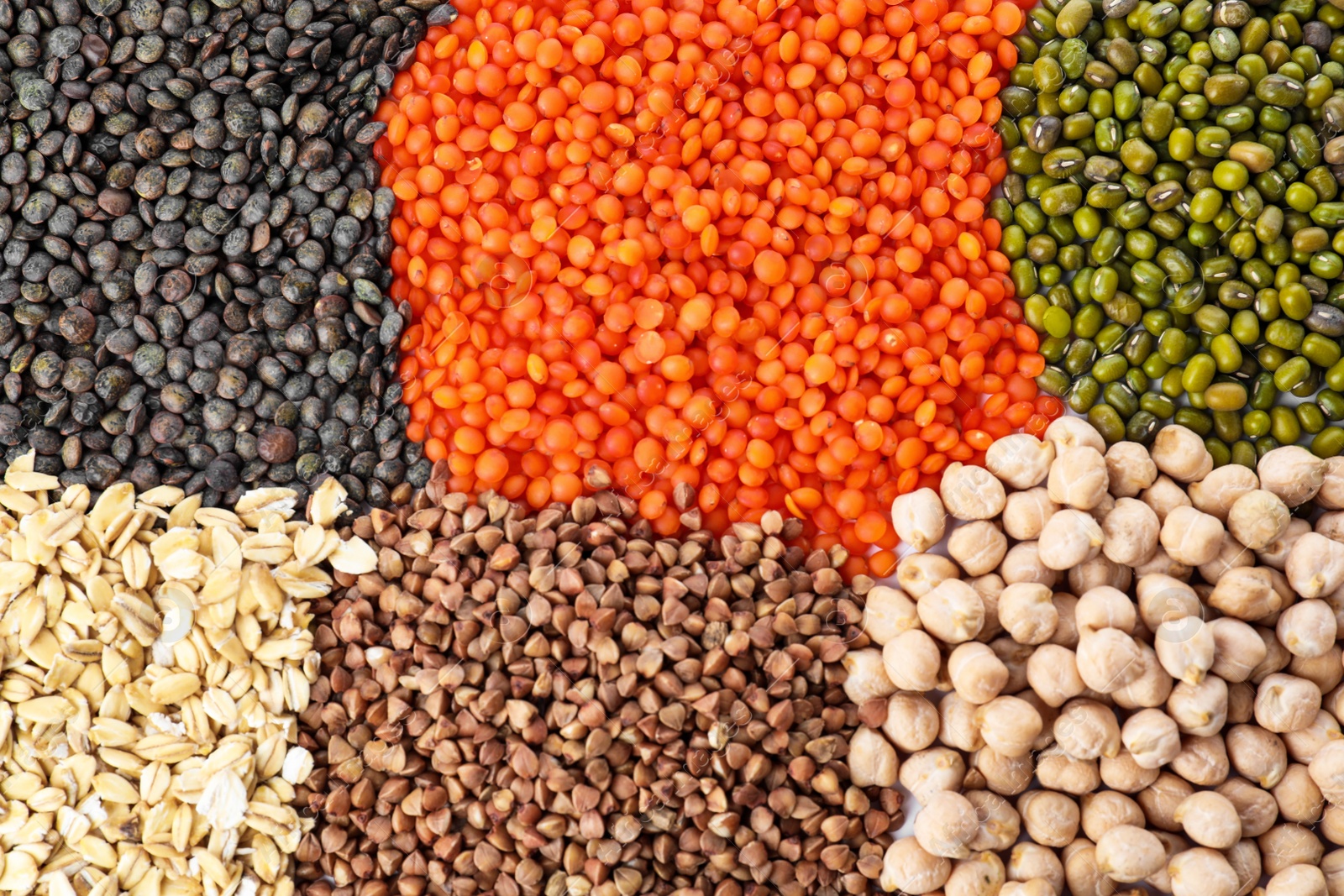 Photo of Different grains and cereals as background, top view