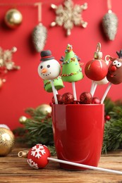 Delicious Christmas themed cake pops on wooden table