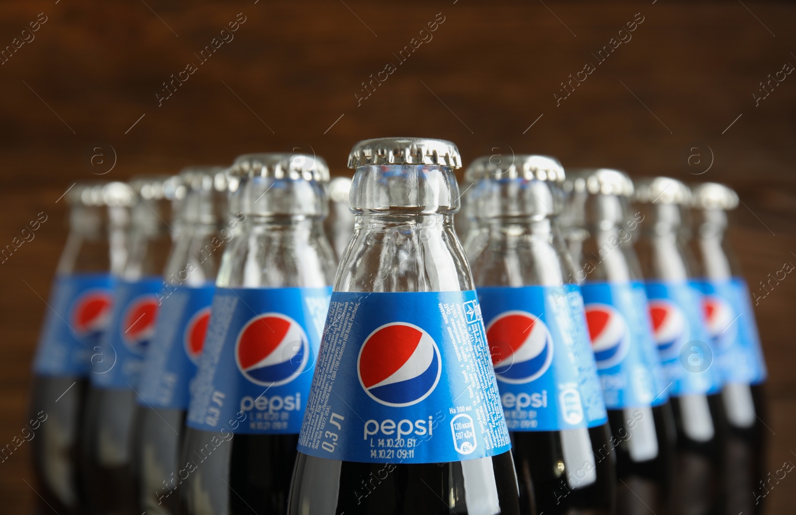 Photo of MYKOLAIV, UKRAINE - FEBRUARY 9, 2021: Many bottles of Pepsi on blurred background, closeup