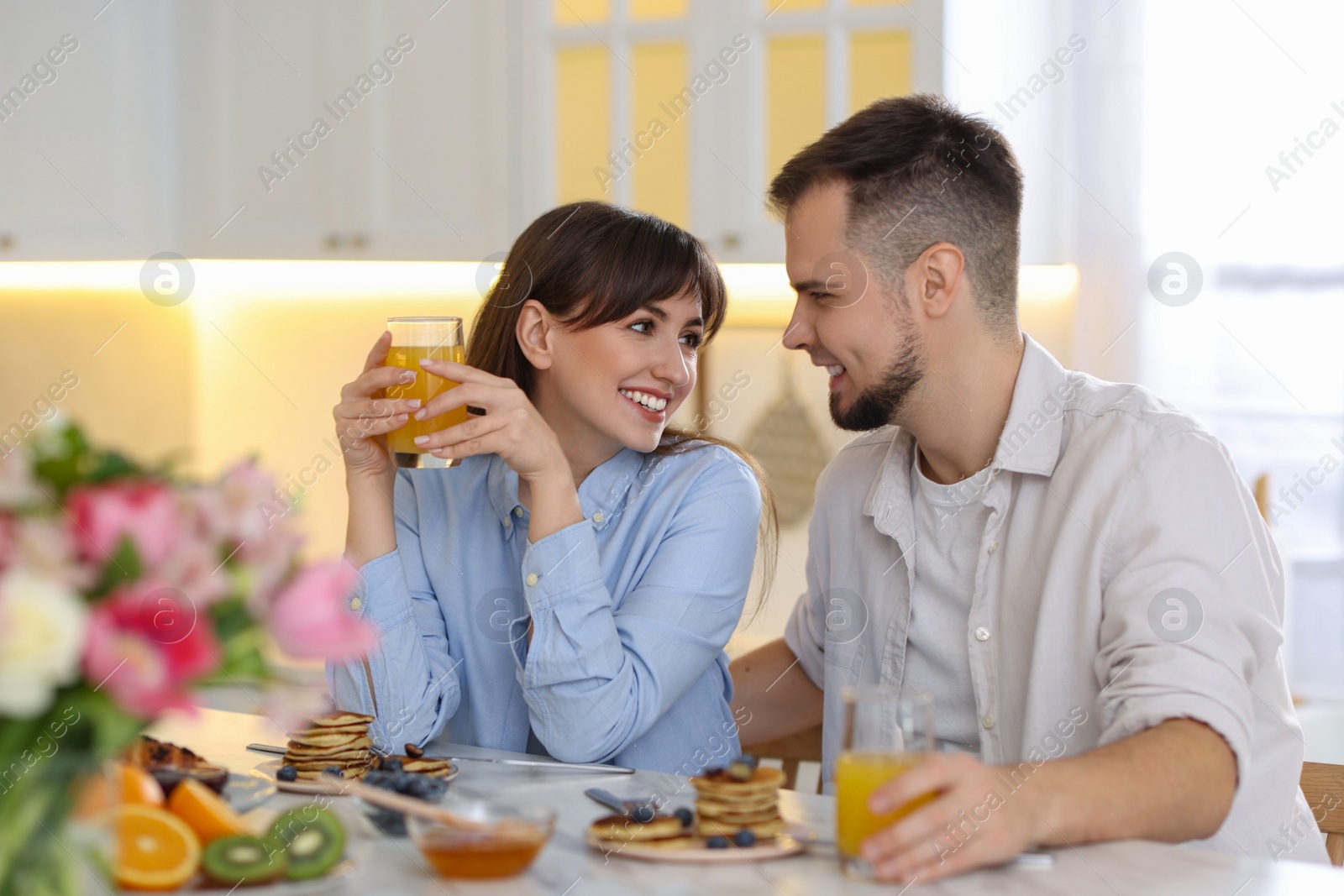 Photo of Happy couple having tasty breakfast at home