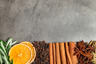 Photo of Different mulled wine ingredients on grey table, flat lay. Space for text