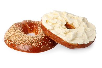 Delicious fresh bagel with cream cheese on white background