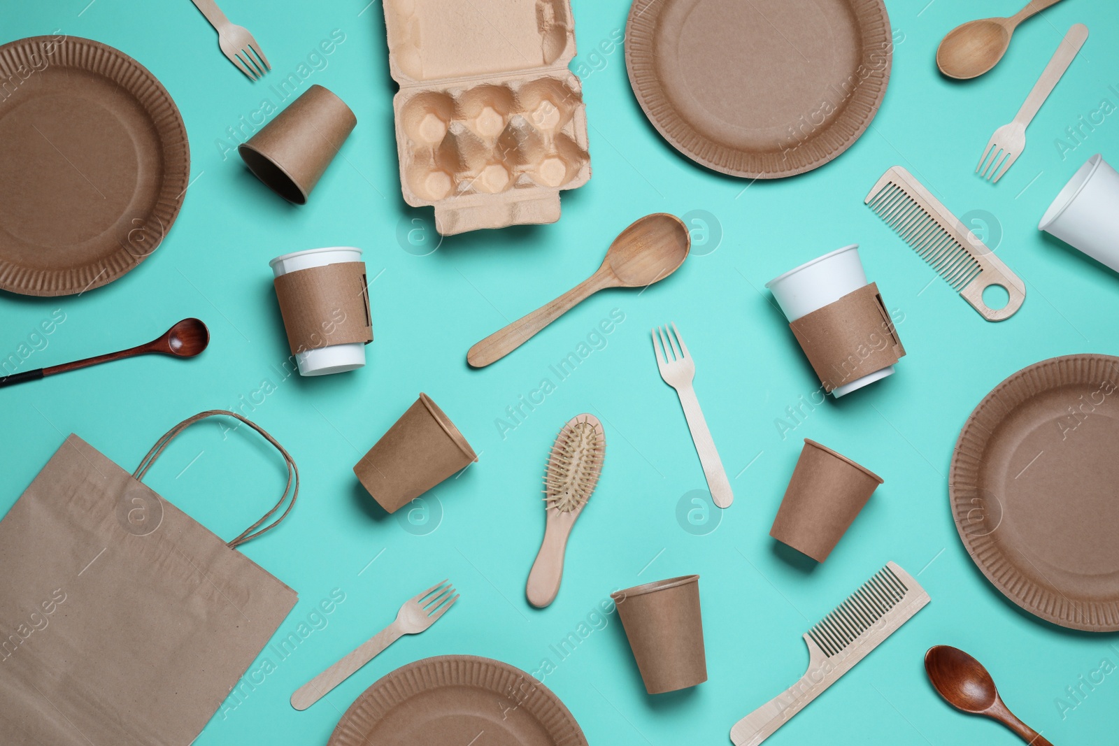 Photo of Different eco items on turquoise background, flat lay. Recycling concept