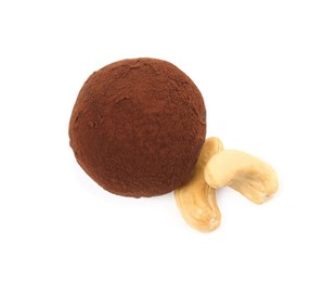 Photo of Delicious chocolate truffle with cocoa powder and cashew nuts on white background, top view