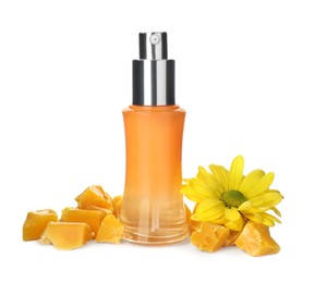 Photo of Bottle of cosmetic product, natural beeswax and flower on white background