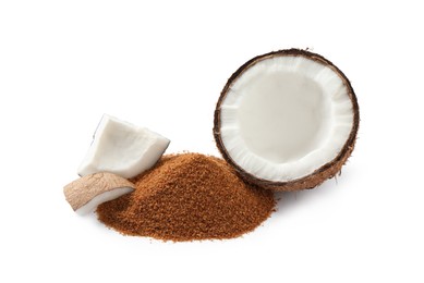 Photo of Ripe coconut and pile of brown sugar on white background