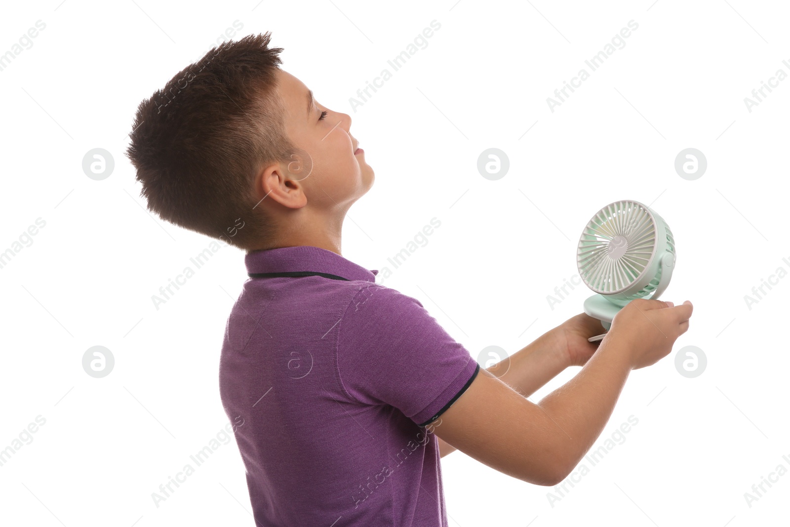 Photo of Little boy enjoying air flow from portable fan on white background. Summer heat