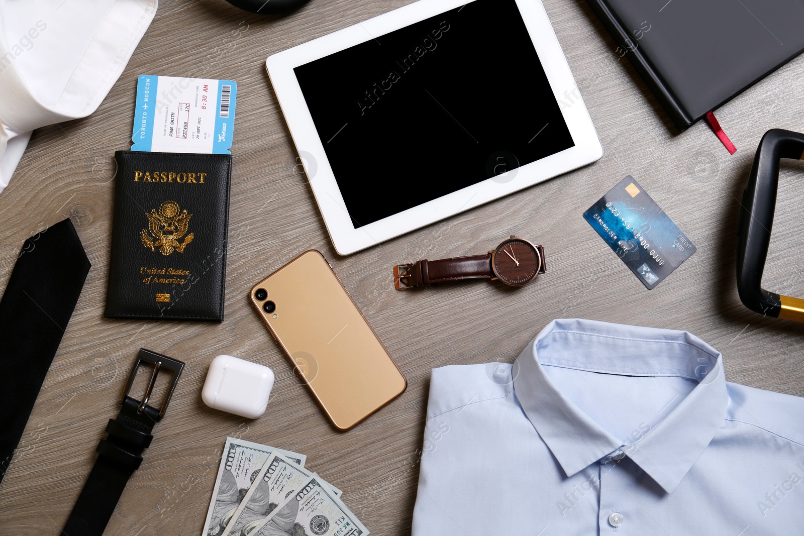 Photo of Business trip stuff on wooden surface, flat lay