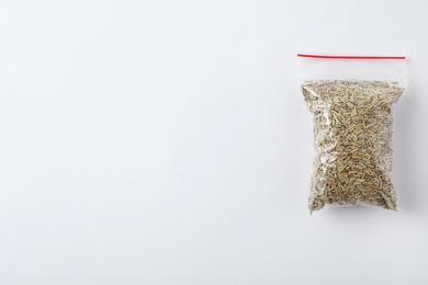 Plastic bag with spice on white background, top view