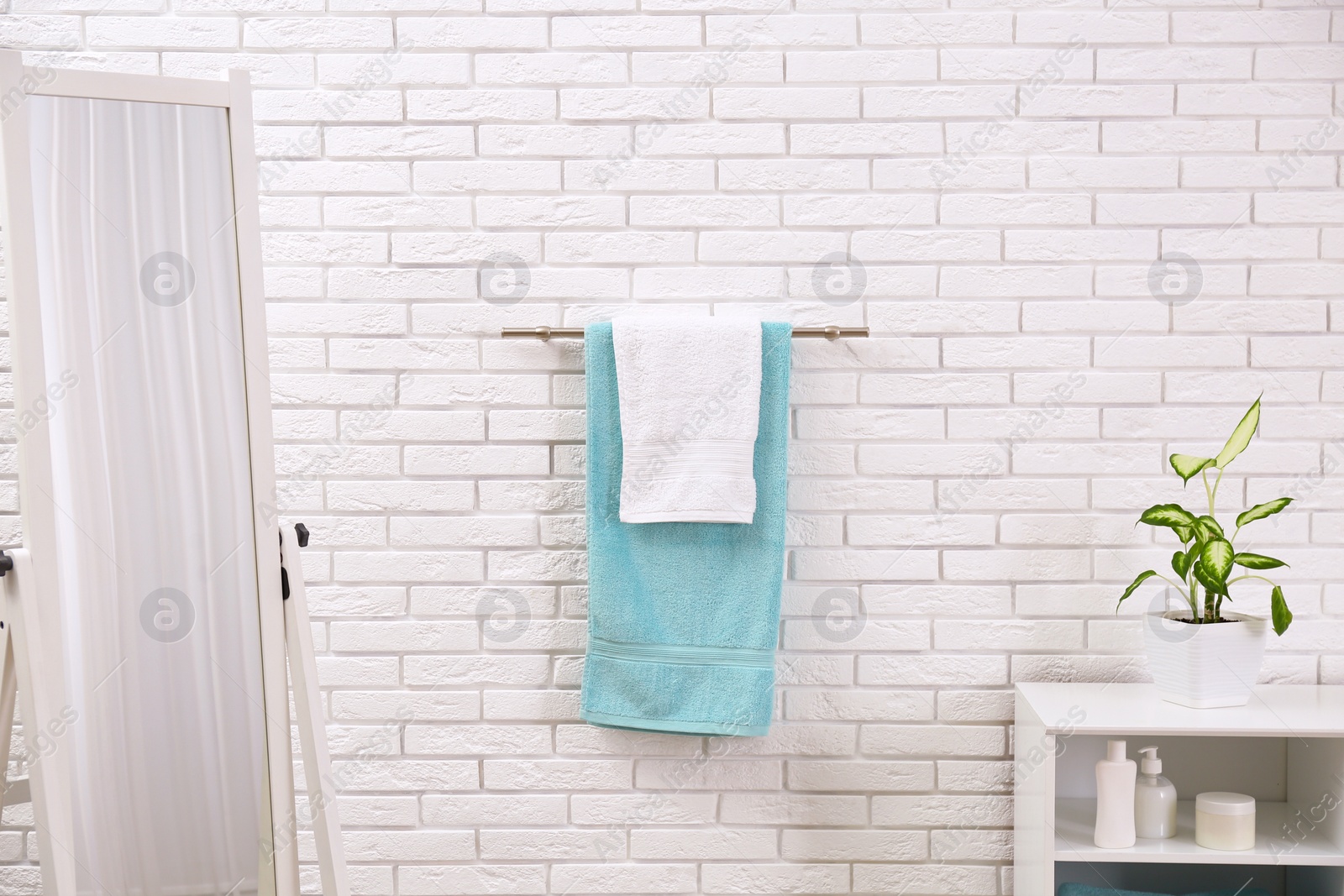 Photo of Fresh clean towels on hanger in bathroom