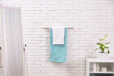 Fresh clean towels on hanger in bathroom