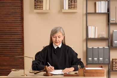Photo of Judge working with document at table indoors