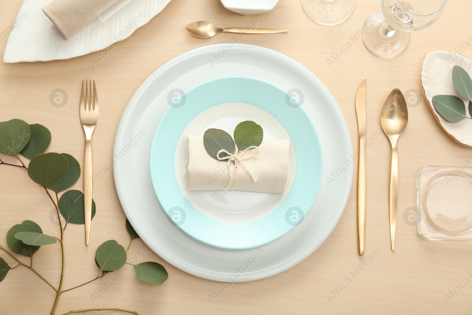 Photo of Elegant table setting with green leaves, flat lay