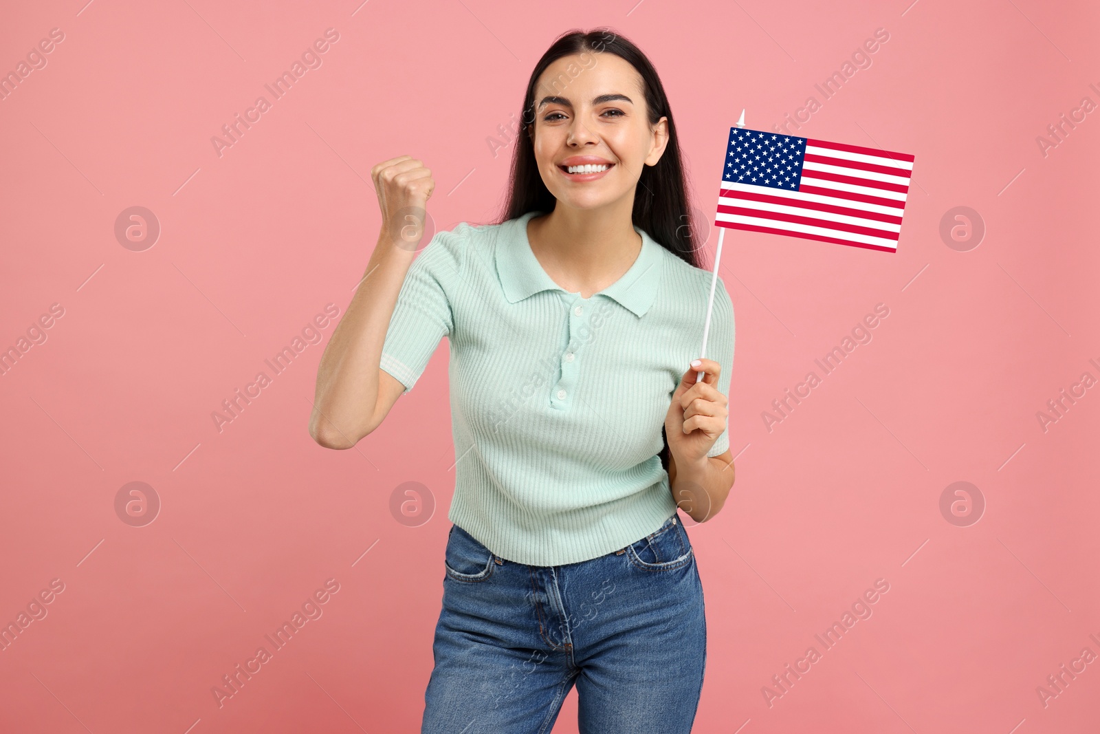 Image of Happy young woman with flag of USA on pink background