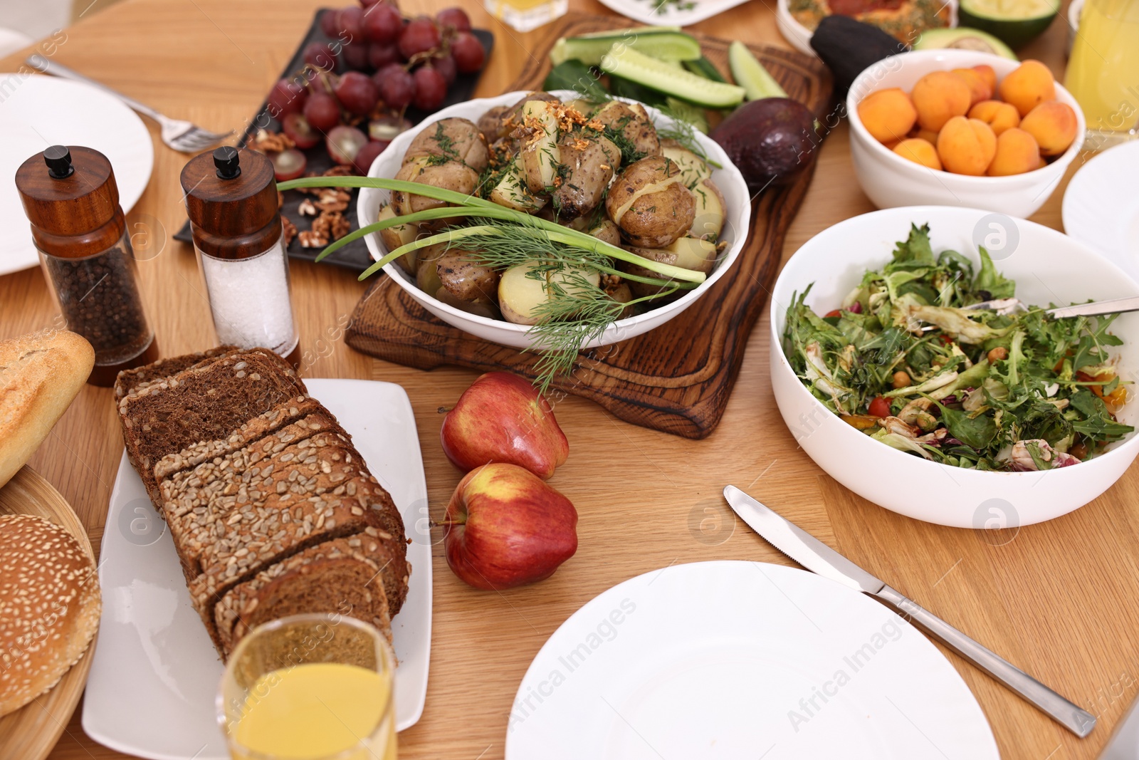 Photo of Healthy vegetarian food and glass of juice on wooden table