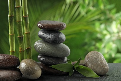 Photo of Composition with stones on table against blurred background. Zen concept