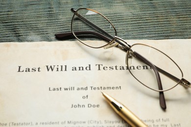 Photo of Last Will and Testament, glasses and pen on rustic wooden table, closeup