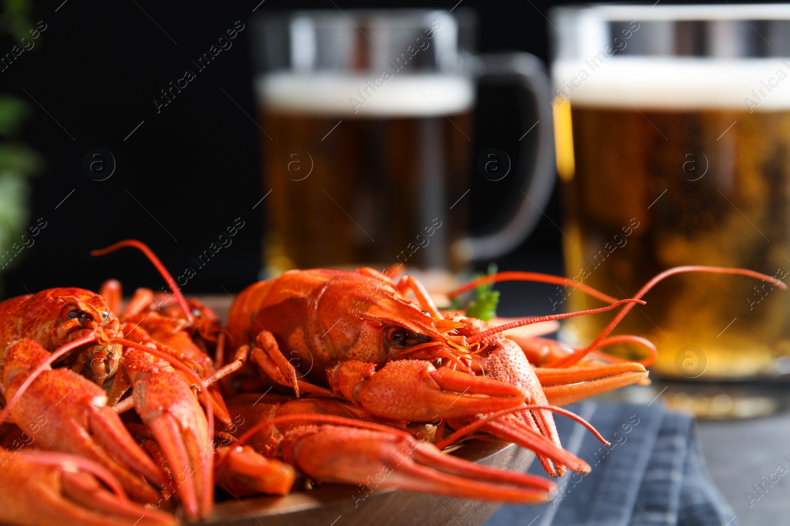 Photo of Delicious red boiled crayfishes on table, closeup