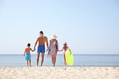 Photo of Family at beach on sunny summer day