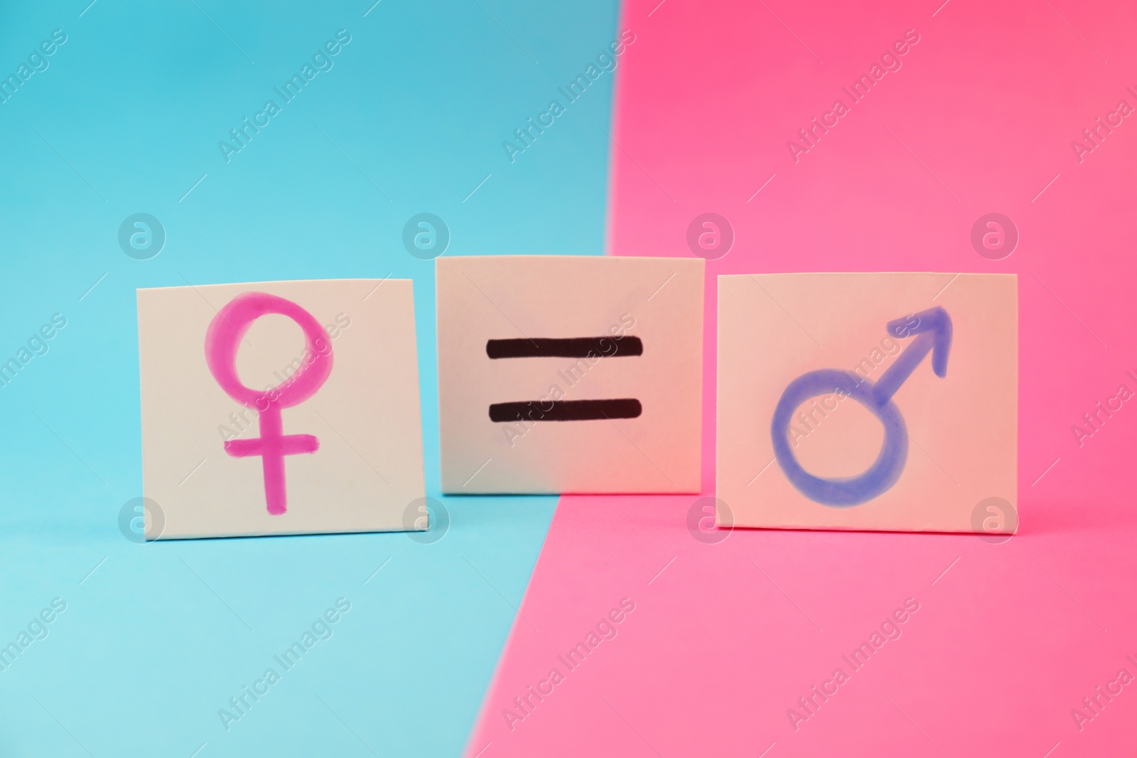 Photo of Gender equality concept. Cards with equal sign and gender symbols on color background