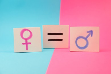 Gender equality concept. Cards with equal sign and gender symbols on color background