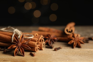 Different aromatic spices on wooden table, closeup