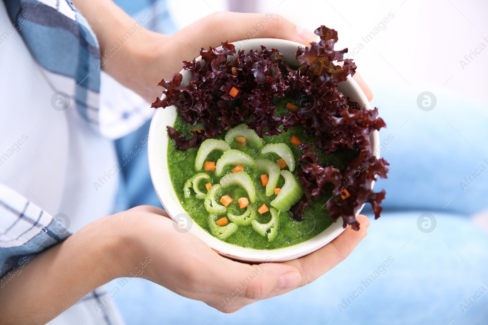 Photo of Young woman with bowl of healthy smoothie, closeup