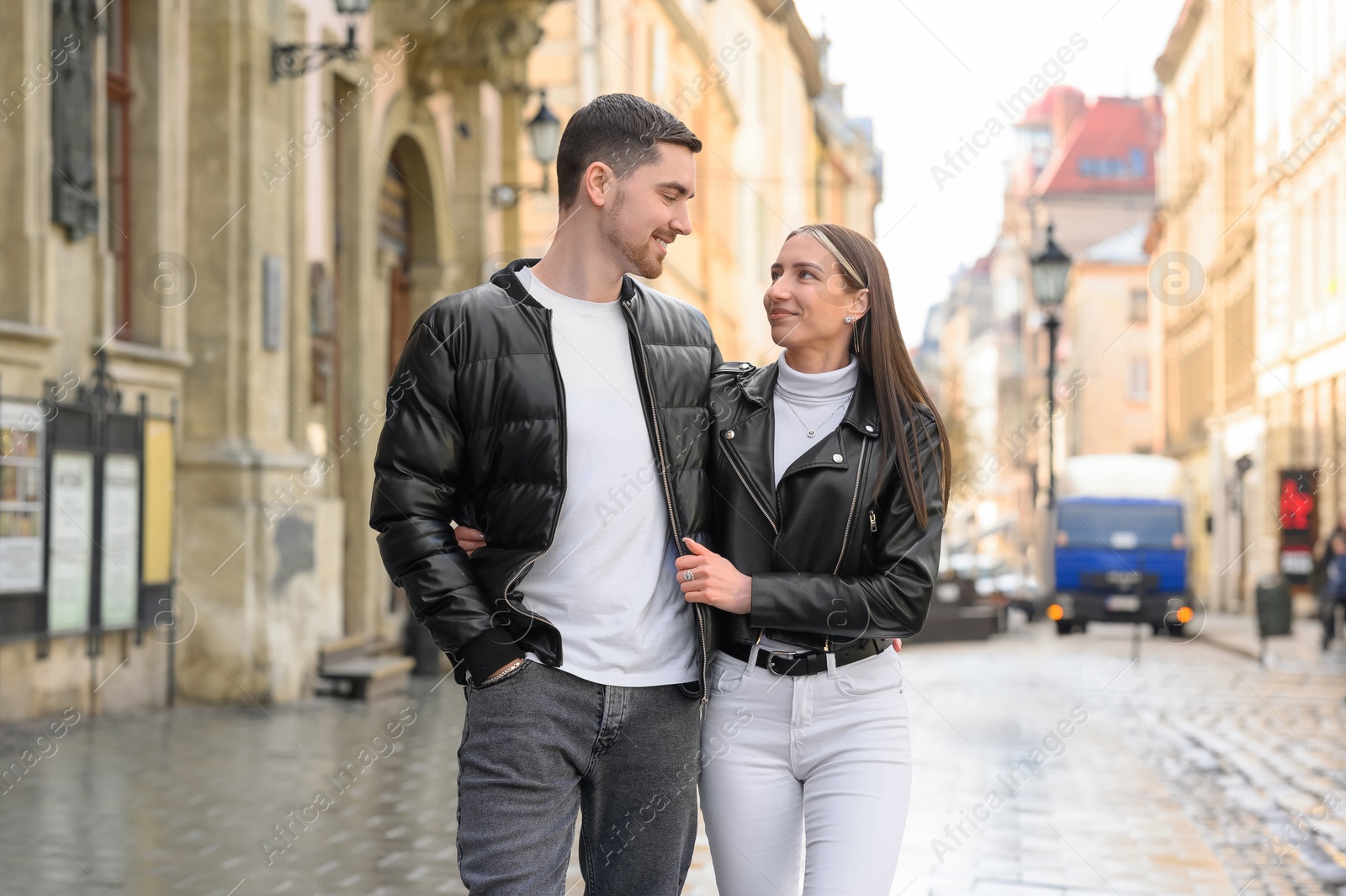 Photo of Lovely young couple walking together on city street. Romantic date