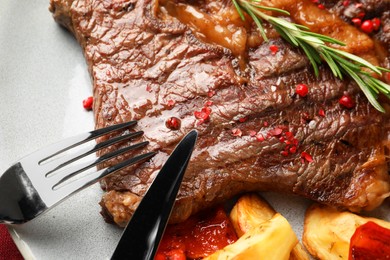 Photo of Delicious grilled beef steak and vegetables on plate, top view