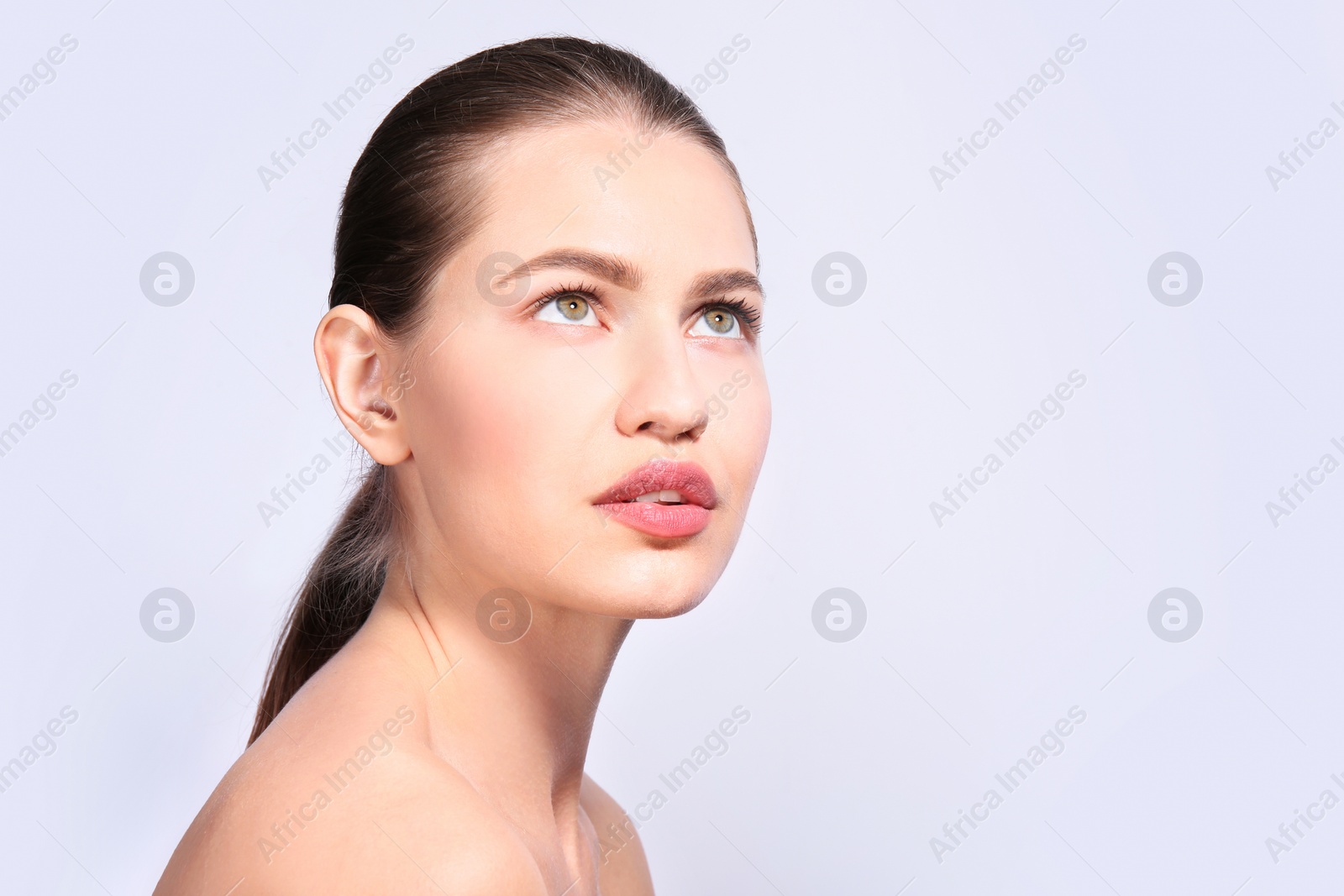 Photo of Beautiful woman with perfect eyebrows on light background