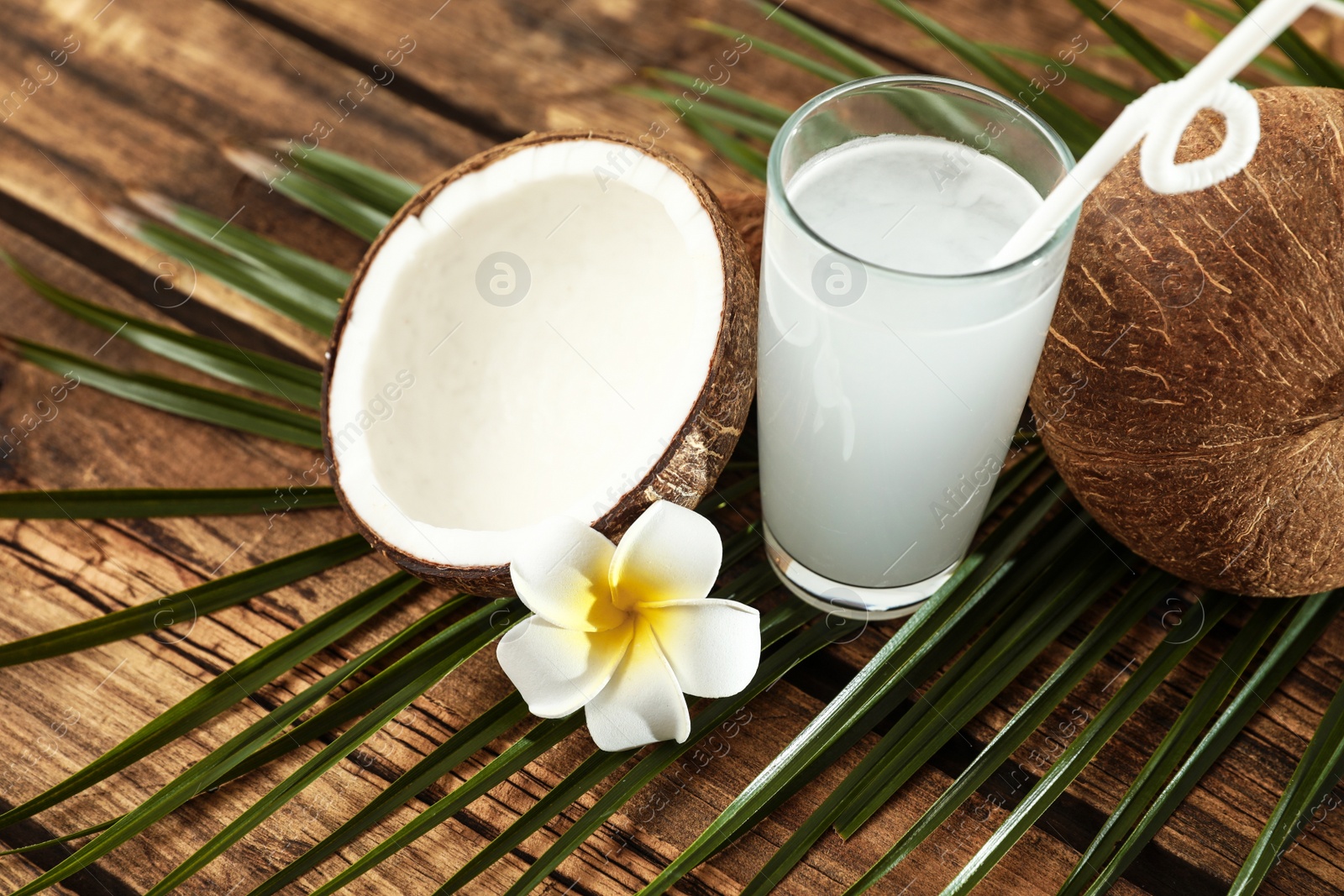 Photo of Composition with glass of coconut water on wooden background