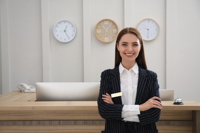 Photo of Portrait of beautiful receptionist near counter in hotel