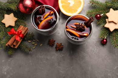 Flat lay composition with aromatic mulled wine on grey table. Space for text