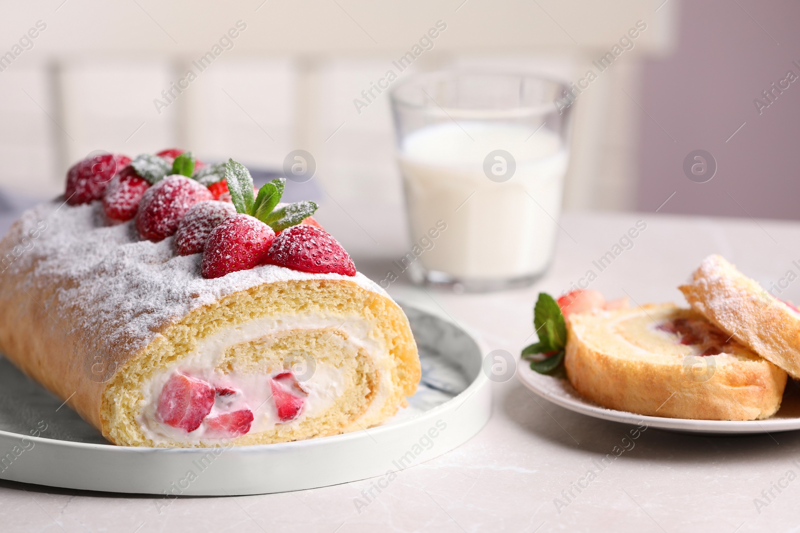 Photo of Delicious cake roll with strawberries and cream on light gray table