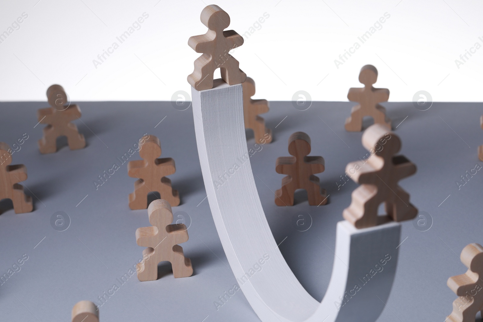 Photo of Recruitment process, job competition concept. Wooden human figures on grey table