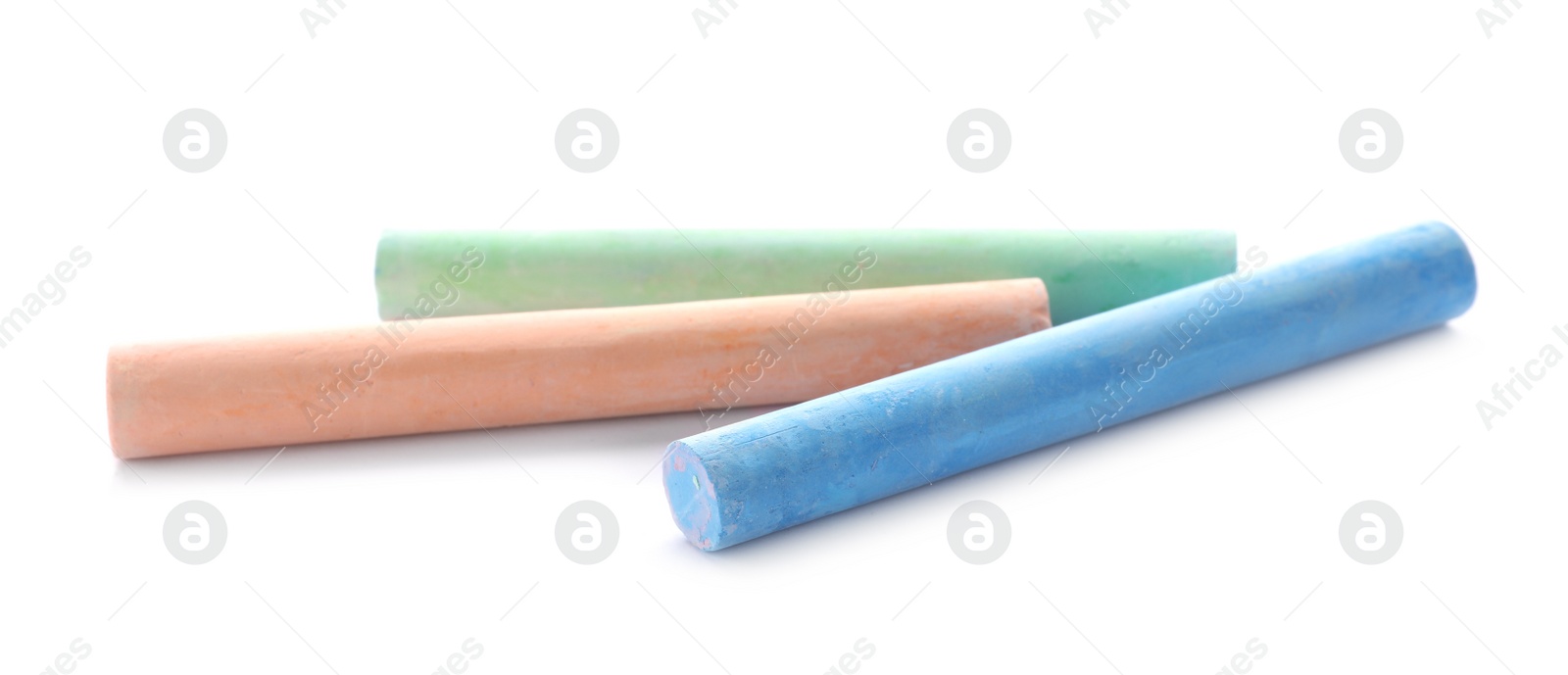 Photo of Color pieces of chalk on white background