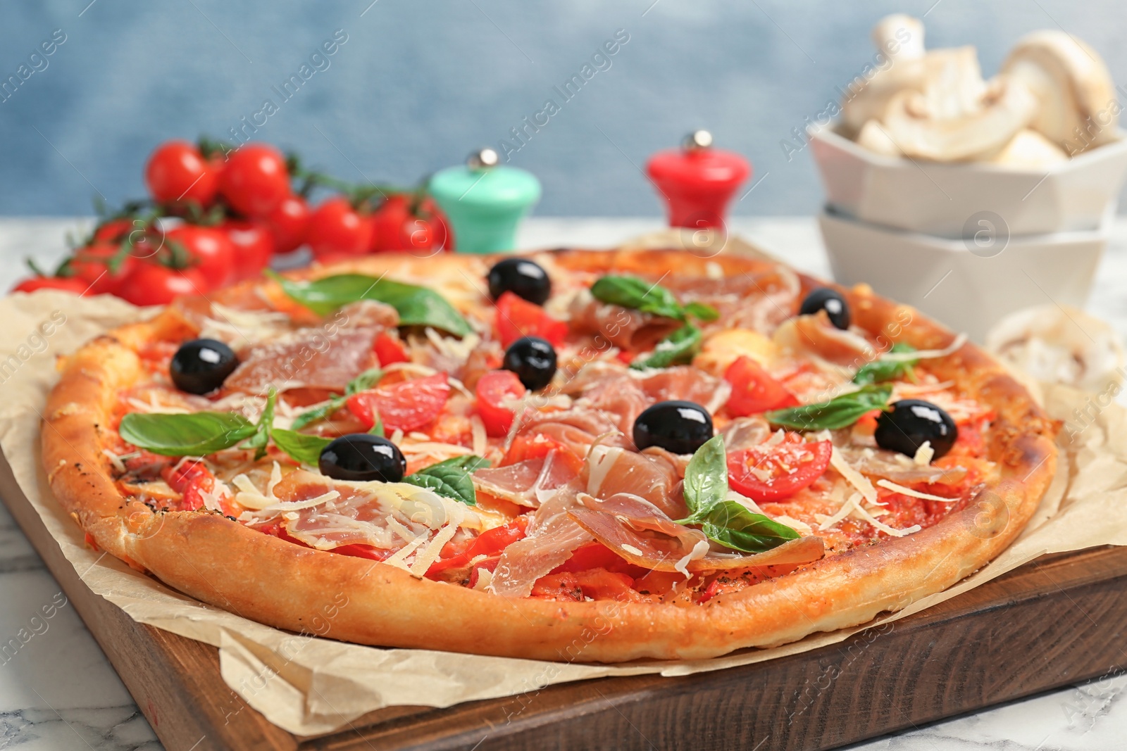 Photo of Delicious pizza with tomatoes and meat on table, closeup
