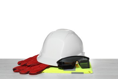 Photo of Personal protective equipment on wooden surface against white background