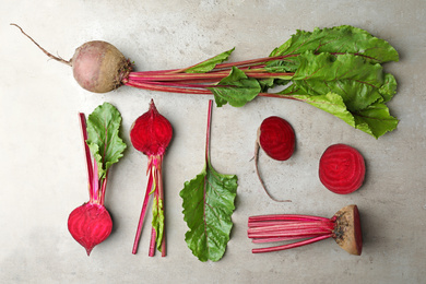 Photo of Flat lay composition with raw beets on light grey table
