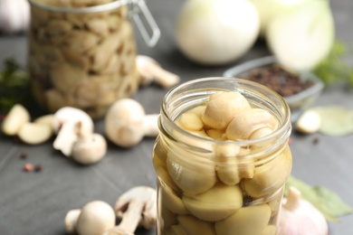 Glass jar of tasty pickled mushrooms, closeup. Space for text