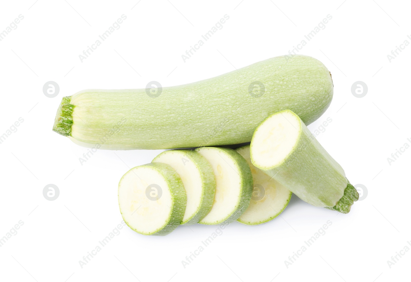 Photo of Cut and whole green ripe zucchinis on white background, top view