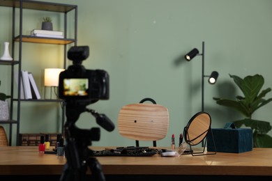 Beauty blogger's workplace. Cosmetic products on table indoors