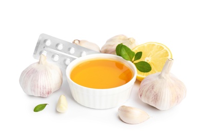 Composition with garlic and other cold remedies on white background