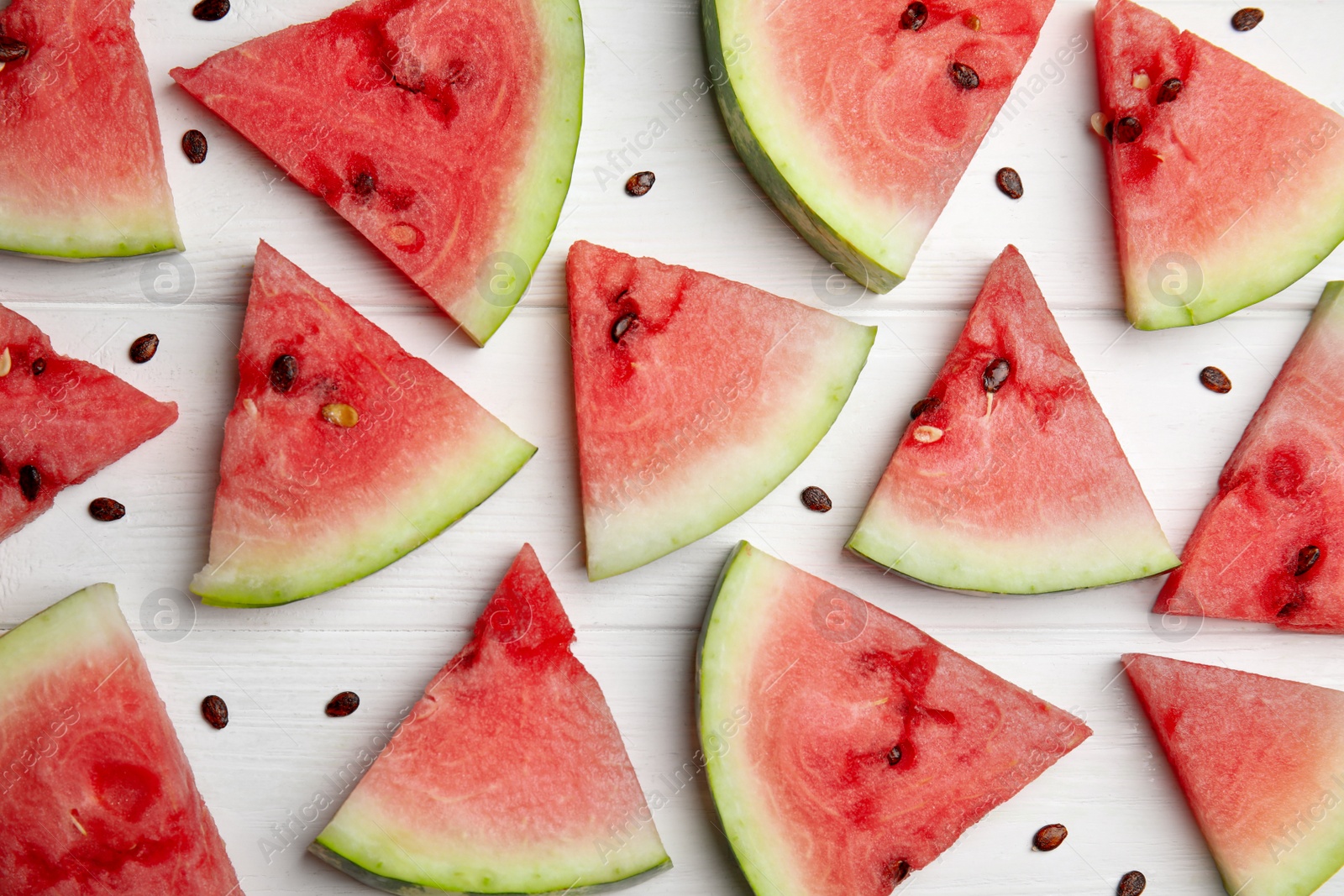 Photo of Watermelon slices on white wooden background, flat lay